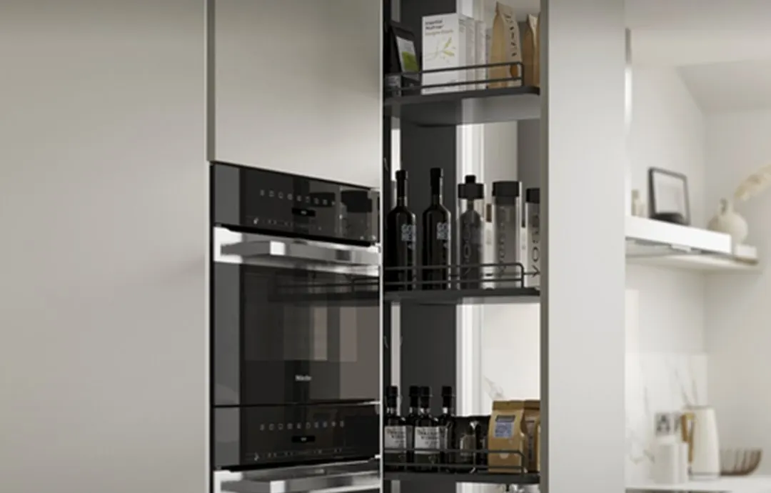 Pull-out pantry beside integrated ovens