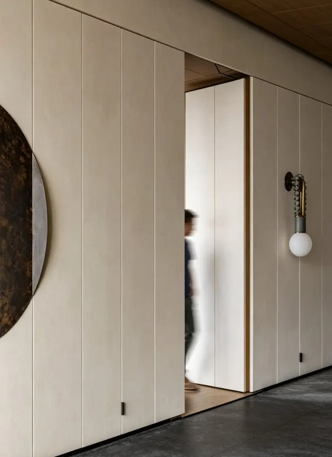 Pivot door set into a panelled wall